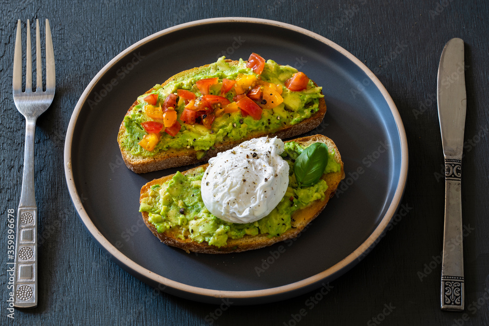 Tasty sandwich with poached egg, avocado and tomatoes Tasty sandwich with poached egg, avocado and tomatoes