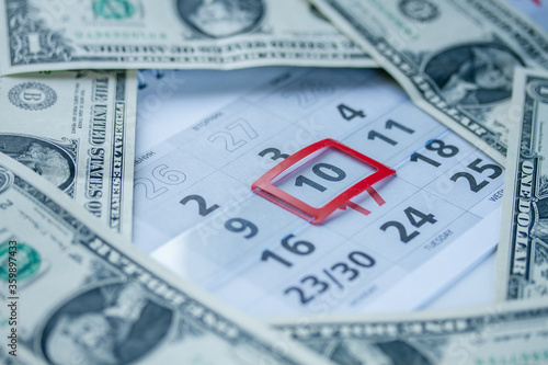 Banknotes of dollars on calendar sheets closeup