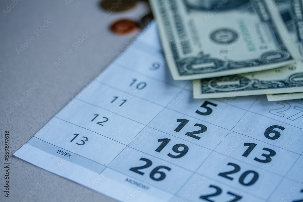 Banknotes of dollars on calendar sheets closeup Banknotes of dollars on calendar sheets closeup