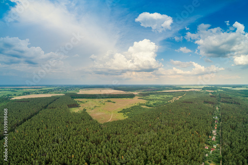 Rural landscape, aerial view, skyview of countryside and pine forest with partially cloudy sky