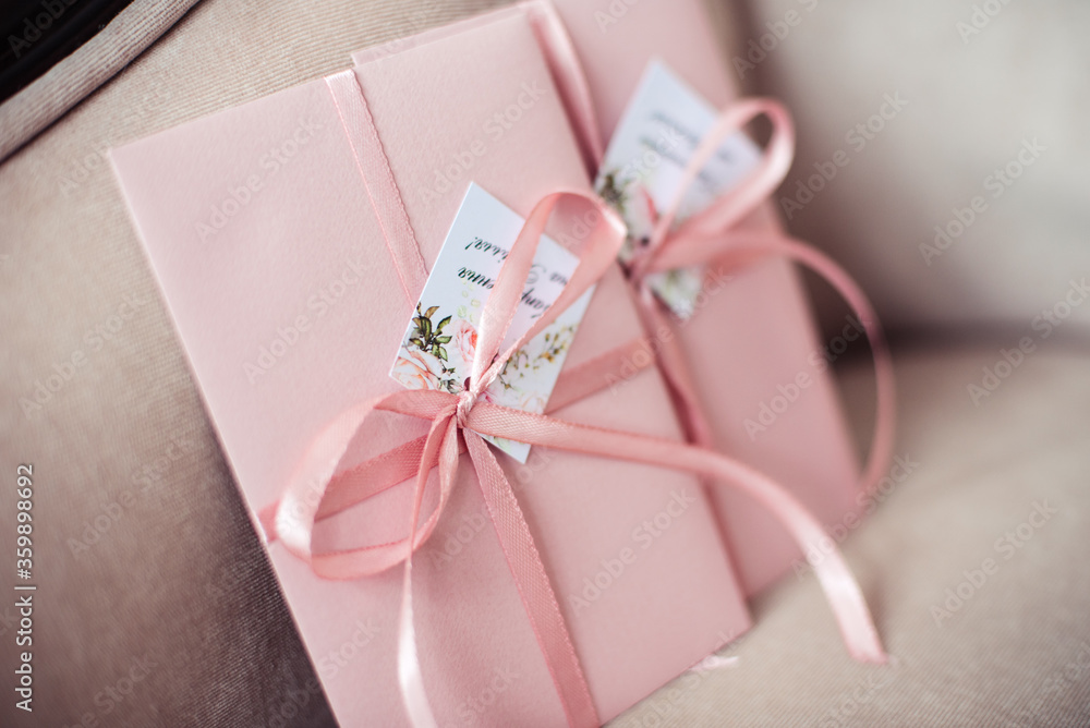 Pink gift certificate, envelope tied with a ribbon. Wedding invitation cards. Pink gift certificate, envelope tied with a ribbon. Wedding invitation cards.