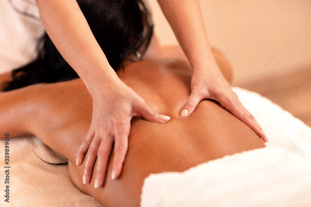 Fototapeta premium Black haired woman enjoying benefits of a massage