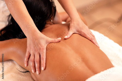 Woman lying on her chest in massage studio