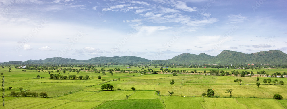 Panorama Green field with mountain background, Thailand.