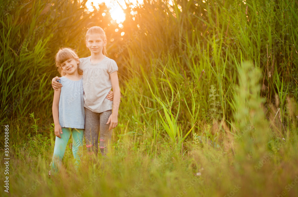 Little kid best friends hugging outdoor at summer Little kid best friends hugging outdoor at summer