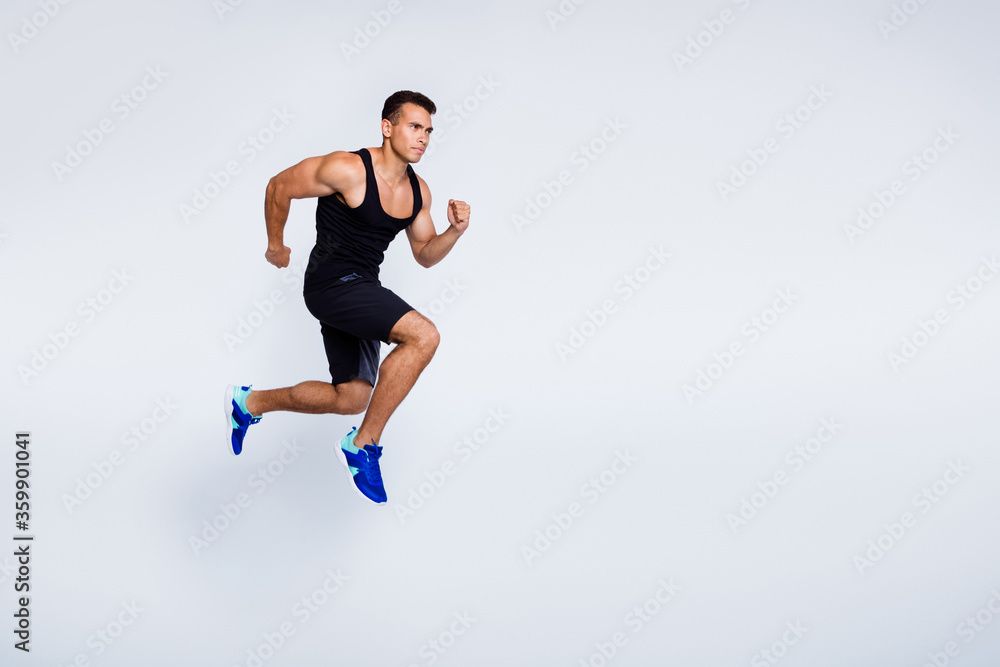 Full length body size view of his he nice attractive muscular focused purposeful guy jumping running jogging sprint distance isolated over light gray pastel color background