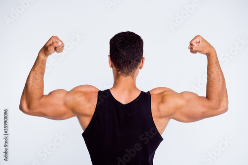 Close-up rear back behind view portrait of his he nice attractive sportive successful guy demonstrating powerful muscles cup championship winner isolated over light gray pastel color background