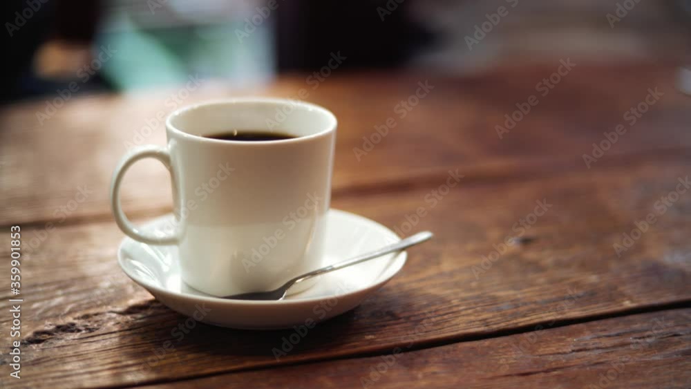 Steam Coming Out Of A Mug Of Hot Coffee Drink On Top Of A Wooden Table. - close up shot Steam Coming Out Of A Mug Of Hot Coffee Drink On Top Of A Wooden Table. - close up shot