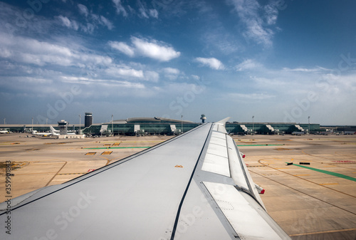 Barcelona-El Prat international Airport seen through the airplane window. This airport is located 10 km from the center of the Barcelona city in Catalonia, Spain. photo