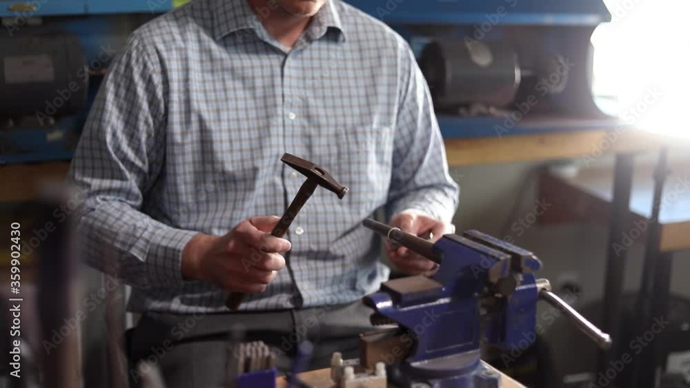 Jeweler Hammering A Ring At A Jewelry Workshop Area. Close up video as jeweler uses a hammer and bit to repair a ring. Jeweler Hammering A Ring At A Jewelry Workshop Area. Close up video as jeweler uses a hammer and bit to repair a ring.