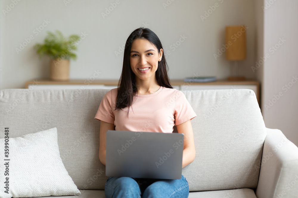 Cheerful Girl Sitting With Laptop On Couch Working From Home Cheerful Girl Sitting With Laptop On Couch Working From Home