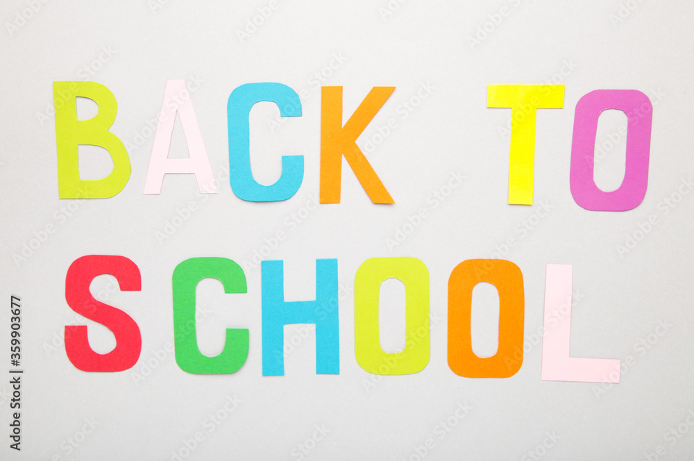 Inscription back to school on grey background Inscription back to school on grey background