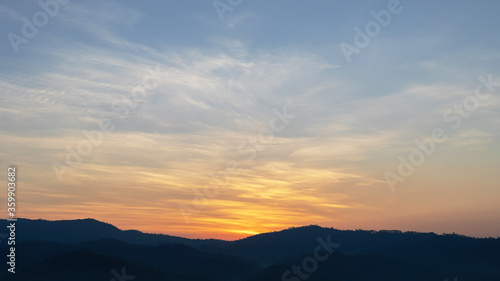 Heaven at early morning with copy space. Smooth orange blue gradient of dawn sky.Sunset, sunrise backdrop.Predawn clear sky with orange horizon and blue atmosphere. Background of beginning of day.