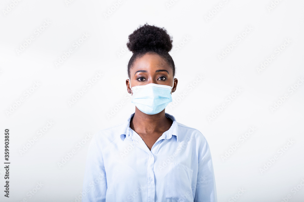 Masked woman - protection against influenza virus. African - American woman wearing mask for protect. Woman wear with protective face mask at home. Stop the virus and epidemic diseases. Masked woman - protection against influenza virus. African - American woman wearing mask for protect. Woman wear with protective face mask at home. Stop the virus and epidemic diseases.