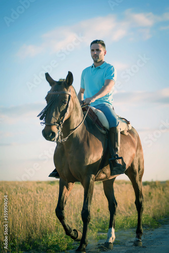 Rider on his horse in the field surrounded by cereal. Practicing horse riding. © fuen30