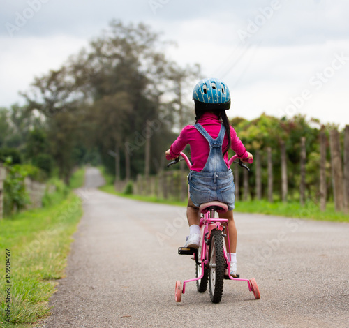 Fototapeta Naklejka Na Ścianę i Meble -  little girl riding a bike