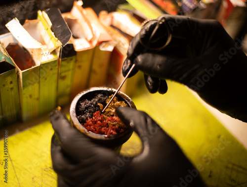 Preparation of Hookah bowl with tabacco leaf hands