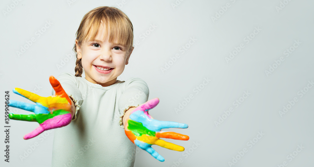 Happy girl showing her colorful painted hands. Child art school student smiling on white background Happy girl showing her colorful painted hands. Child art school student smiling on white background