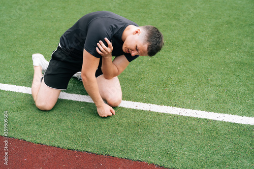Billede på lærred athlete holds his shoulder, elbow pain
