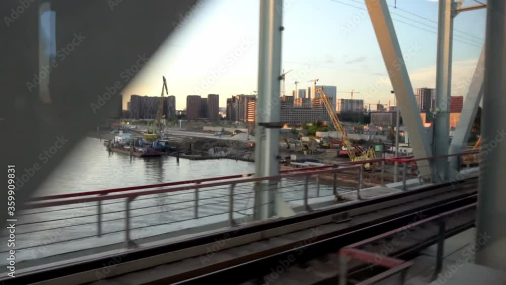 View from the window of a train moving across the river on the railway bridge View from the window of a train moving across the river on the railway bridge