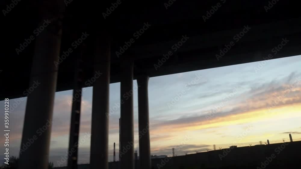 Industrial landscape at sunset, view from the train window Industrial landscape at sunset, view from the train window