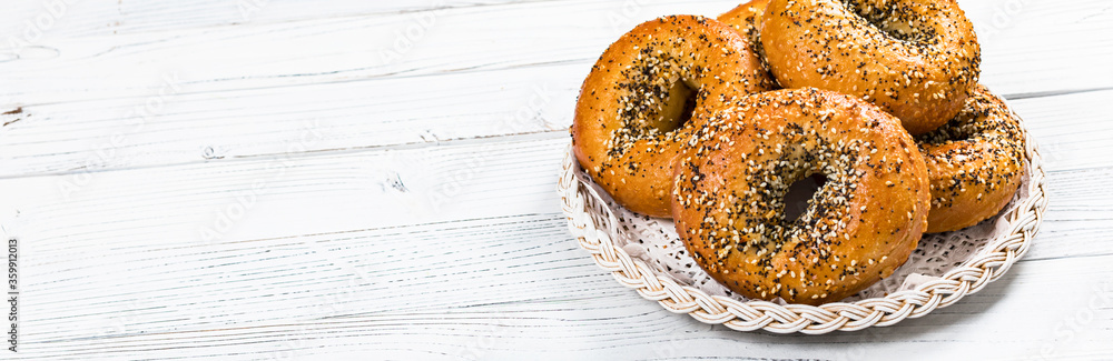 Freshly Baked Bagels Topped with Sesame Seeds, Poppyseeds, Garlic and Onion. Selective focus. Freshly Baked Bagels Topped with Sesame Seeds, Poppyseeds, Garlic and Onion. Selective focus.