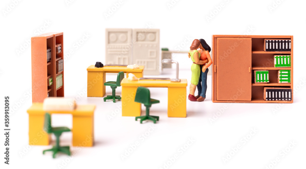 Miniature people female couple. Love at the office Miniature people female couple. Love at the office