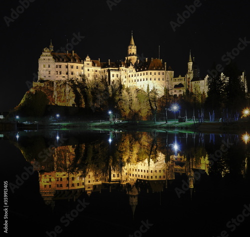 Sigmaringen castle at night with reflection in the river