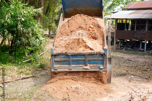 The truck is loading the soil to fill the ground.