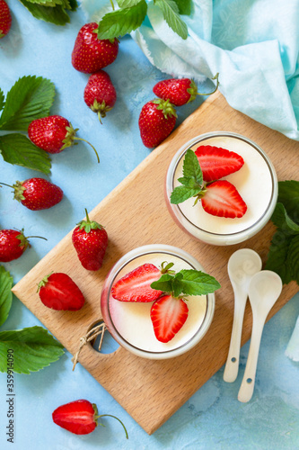 Panna Cotta with jelly strawberries, Italian dessert, home cooking. Top view flat lay background.
