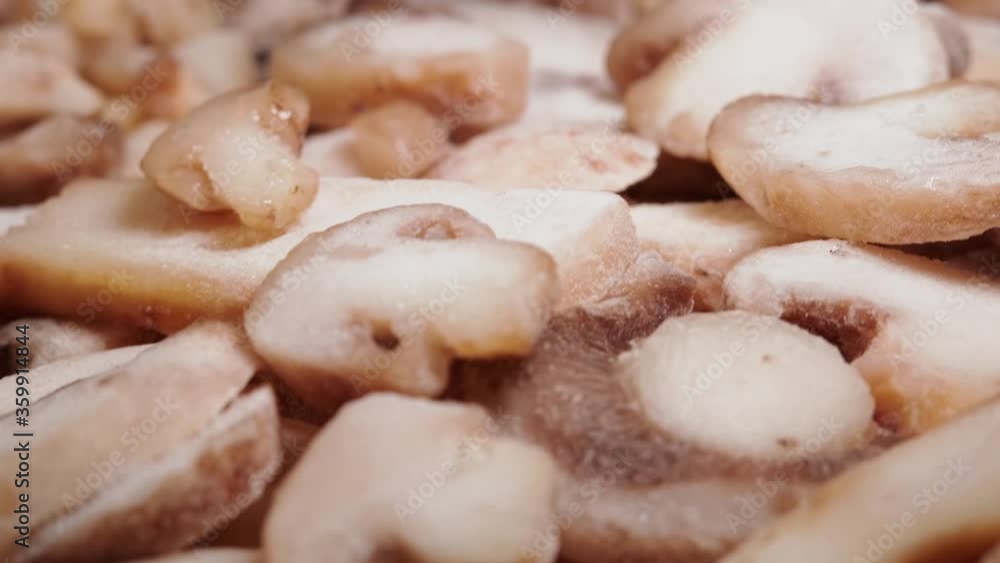 Fresh frozen mushrooms lie on a wooden table. Frozen products, food. Slider motion. Fresh frozen mushrooms lie on a wooden table. Frozen products, food. Slider motion.