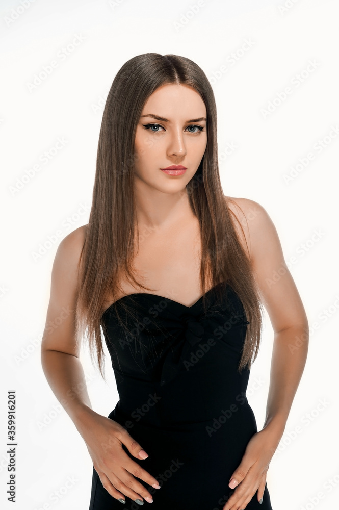 slender girl in overalls. Sports girl in tight clothes. Athletic brunette on a white background slender girl in overalls. Sports girl in tight clothes. Athletic brunette on a white background