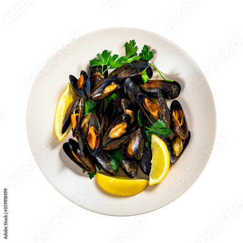 Delicious Seafood Mussels with Lemon and Parsley. Clams in the Shells Isolated on White Background. Selective focus.