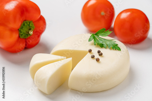 Georgian cheese suluguni with tomatoes, parsley and pepper