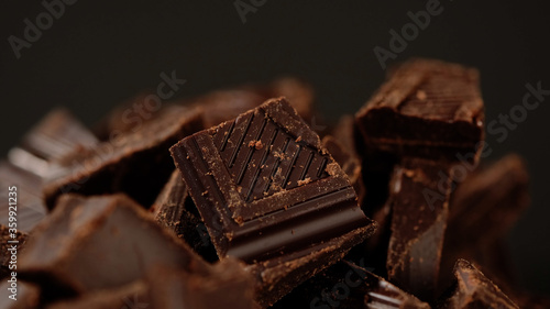 Chunks of sweet dark chocolate, close up, macro shot. Gourmet dessert ingredient