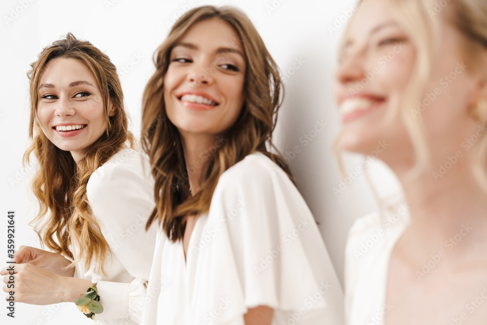 Photo of cheerful bridesmaids laughing and looking at each other Photo of cheerful bridesmaids laughing and looking at each other