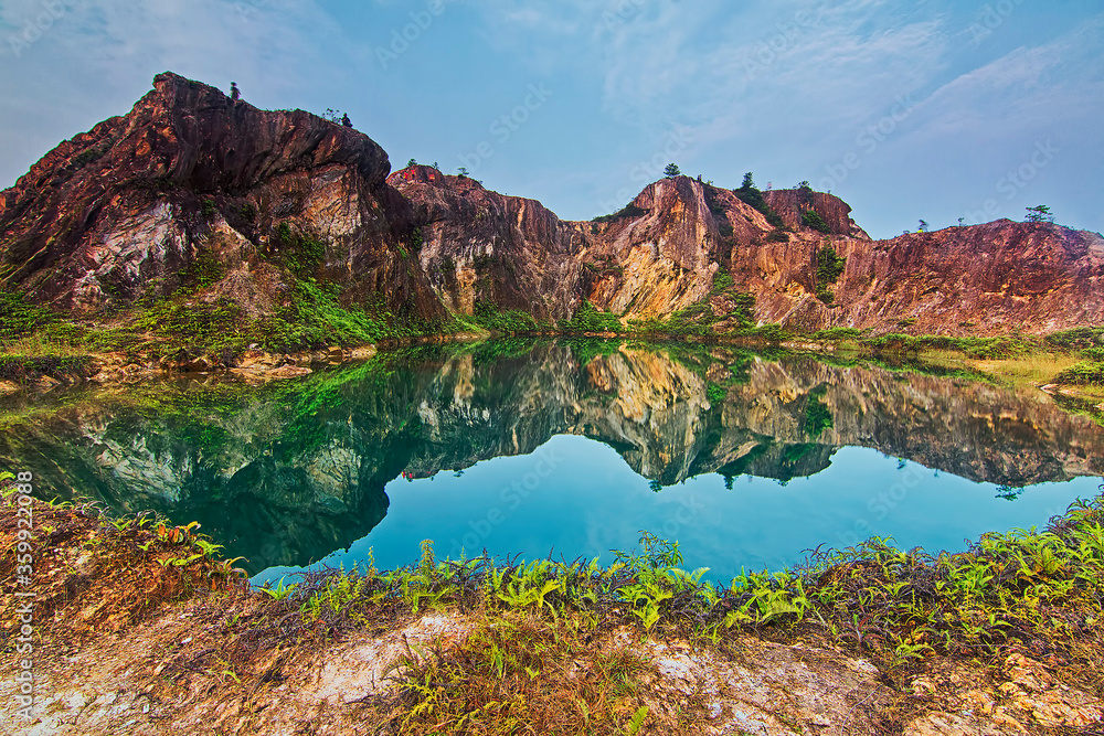 Guar Petai, Penang nature view with reflection of a rock mountain from a man made lake