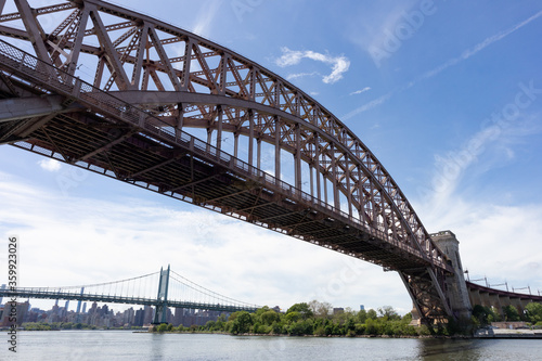 The Hell Gate Bridge over the East River with the Triborough Bridge in the Background in New York City