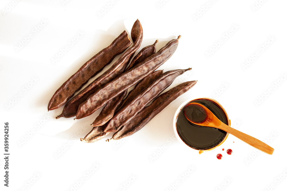 Goat horn and molasses. Photo of molasses on a white background. 素材庫相片
