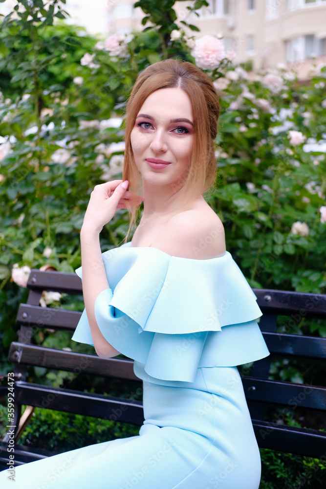 Naklejka premium .Portrait of a young woman in beautiful dress, happy and smiling girl