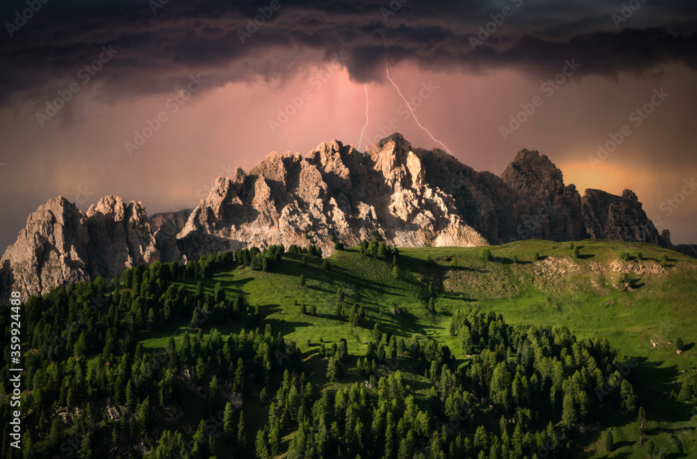 Dramatic clouds and lightning over mountain in Dolomite, Italy