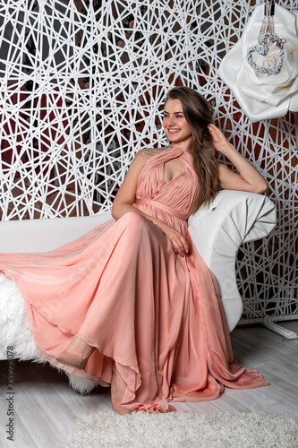 beautiful girl in a crown and a hat. beautiful girl in a long dress