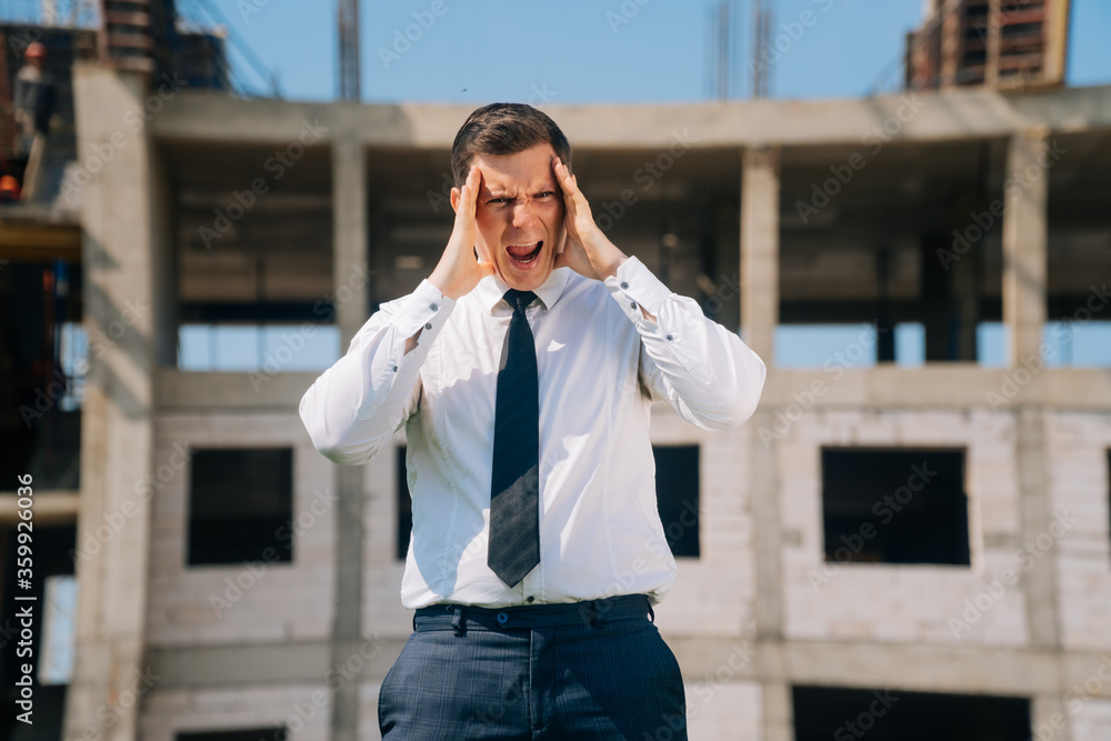 Fototapeta premium man covered his face with his hand in his palm, surprised apartment specialist