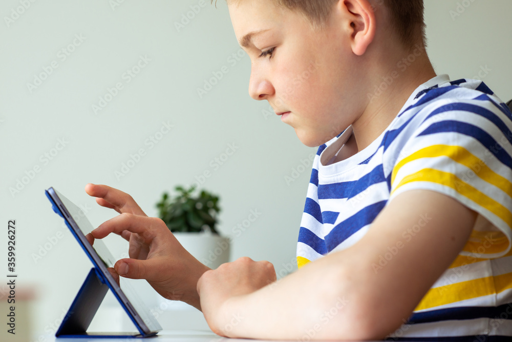 Portrait of teenager boy studying with tablet at holidays Portrait of teenager boy studying with tablet at holidays