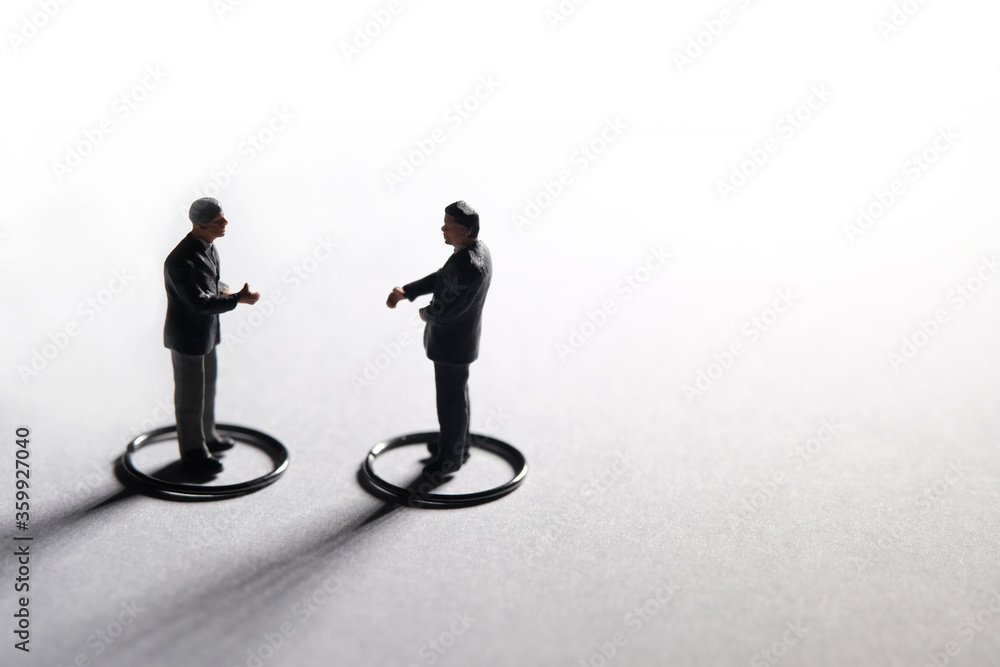 Two businessmen make partnership agreement with maintain physical distance. Miniature people conceptual photography Two businessmen make partnership agreement with maintain physical distance. Miniature people conceptual photography