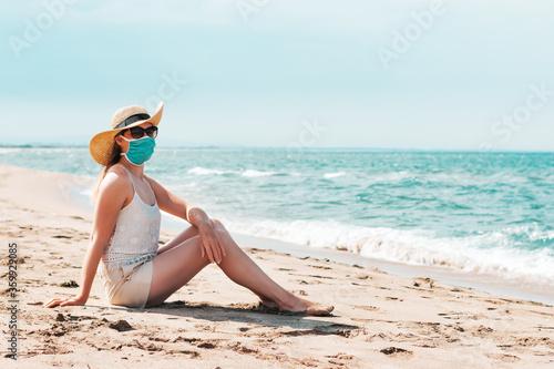 Woman in sunglasses and straw hat wearing medical mask at beach, new normal rules, web banner. Life after pandemic, obligatory use of face mask in public spaces, copy space