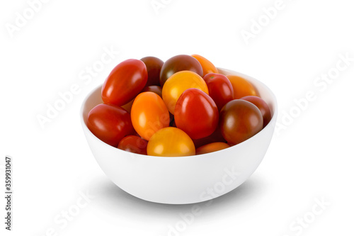 Different sorts of tomatoes served on a white bowl isolated on white background.