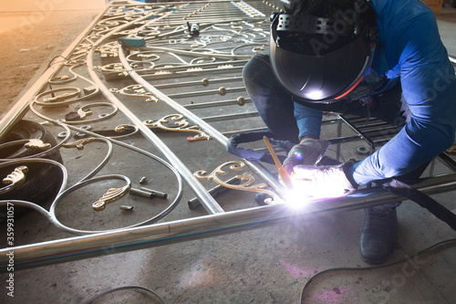 Canvas Print Welders are welding the various parts of building a stainless steel door