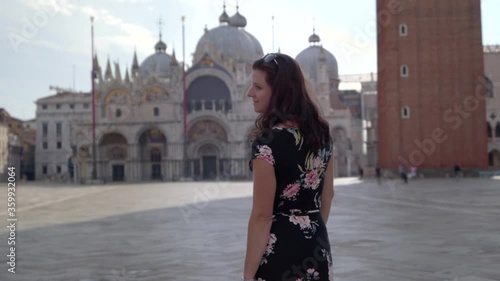 Wallpaper Mural Attractive young woman walking on Square San Marco in Venice Italy looking at the Basilica of San Marco Torontodigital.ca
