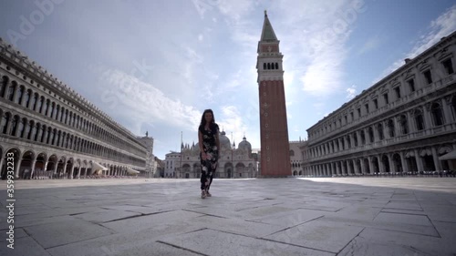 Wallpaper Mural Attractive young woman walking on Square San Marco in Venice Italy looking at the Basilica of San Marco Torontodigital.ca